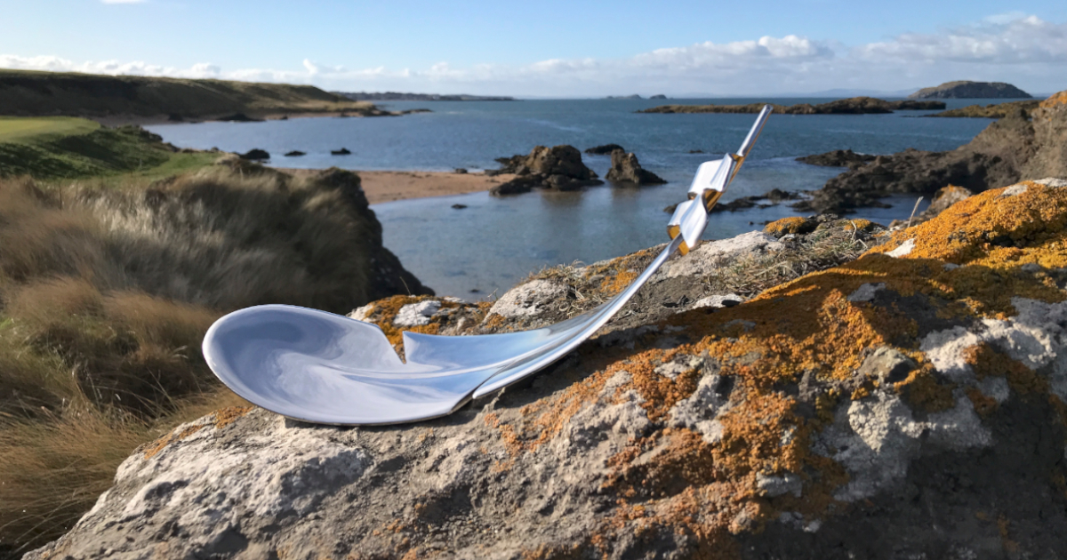 Silver feather sculpture on a rock by the sea at North Berwick