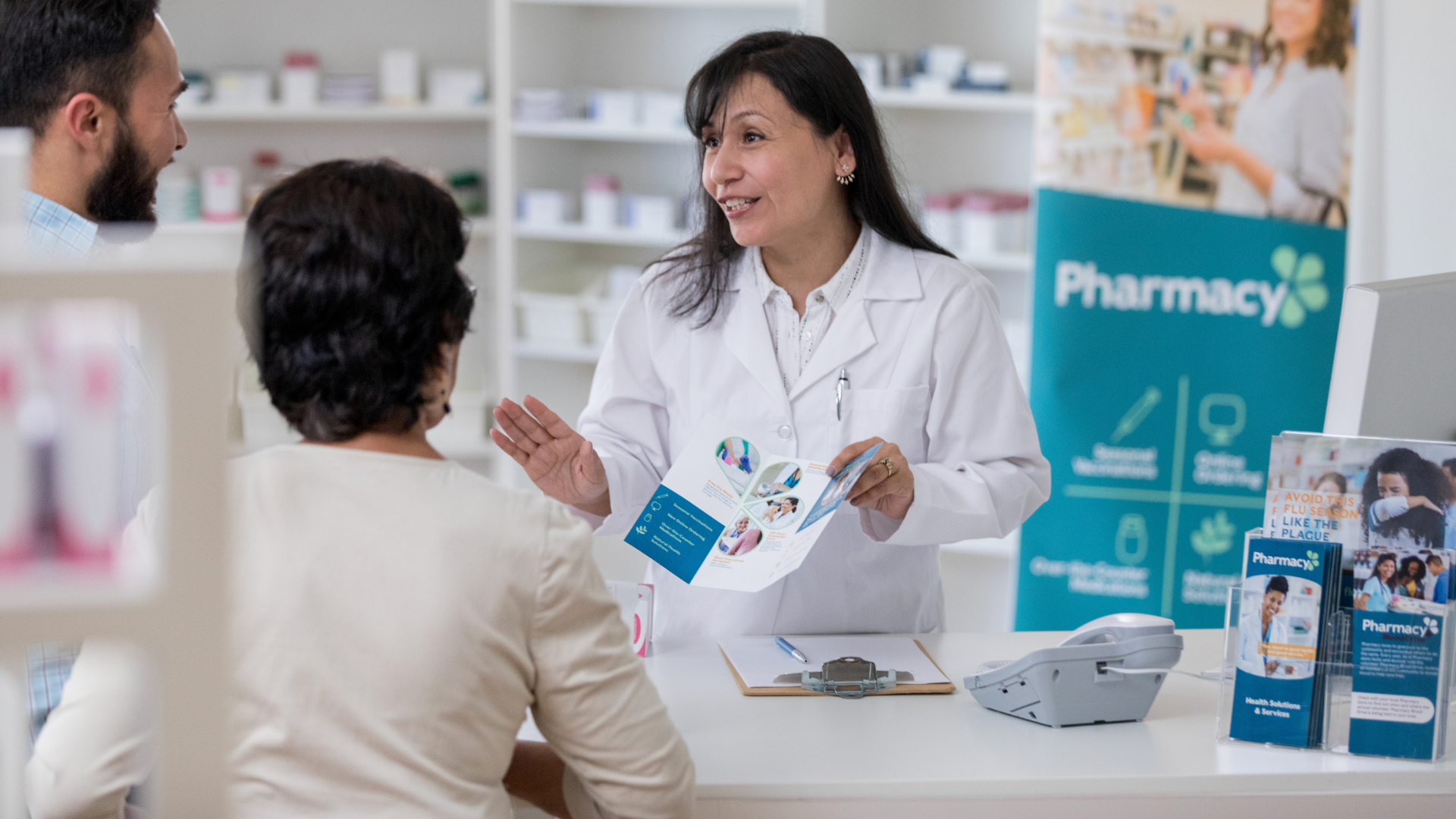 couple standing at a pharmacy counter