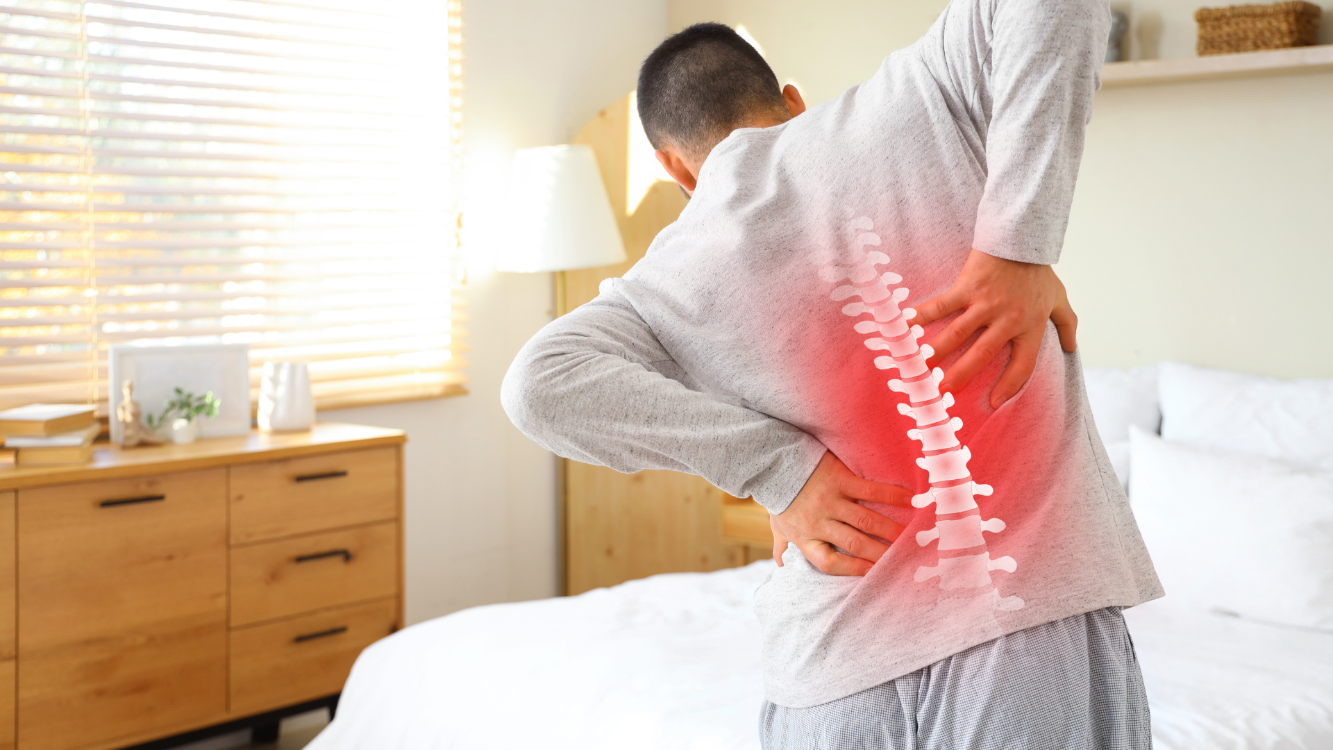 male holding back indicating pain 