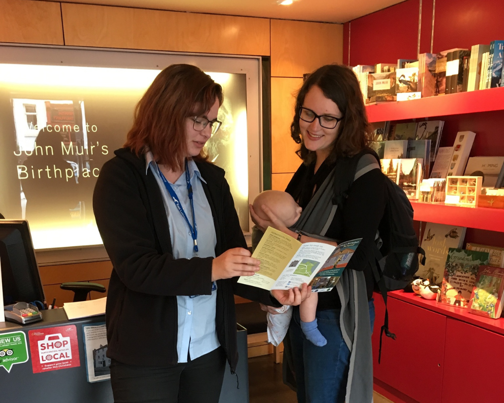 staff member welcoming woman and baby