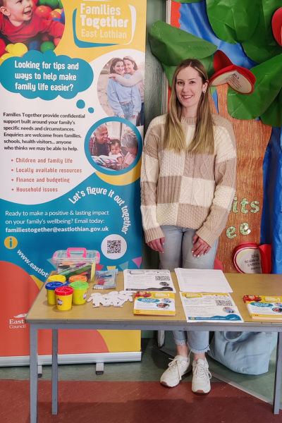 Marissa Durnan, Community Research Officer at a roadshow behind a Families Together stall.