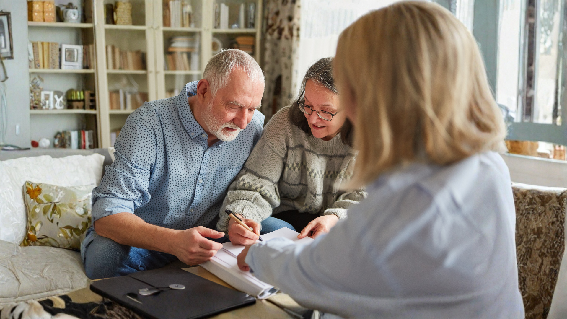 couple sitting on a soft signing legal documents