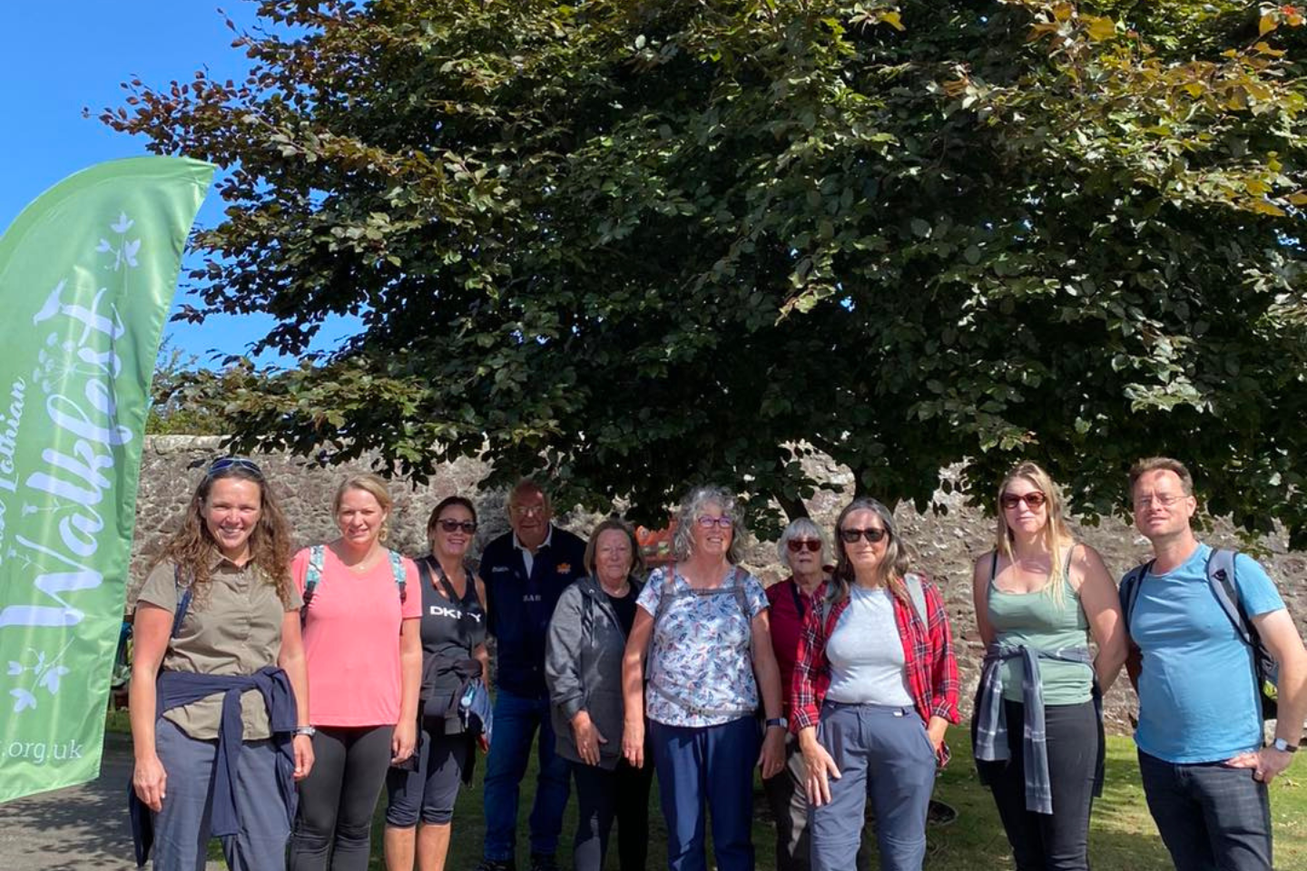 A countryside ranger leading an adult walk as part of Walkfest on a sunny day.