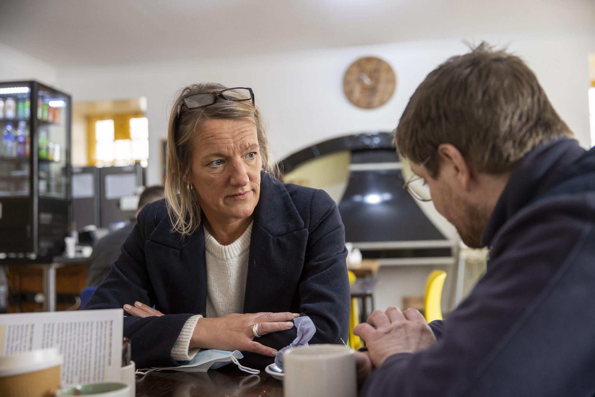 male speaking to woman in a cafe