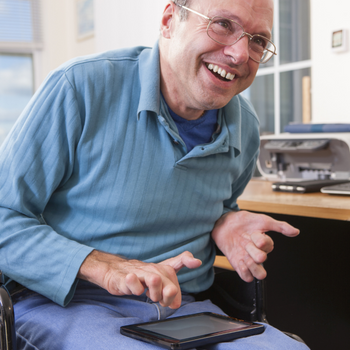 Man with physical disability interacting with ipad