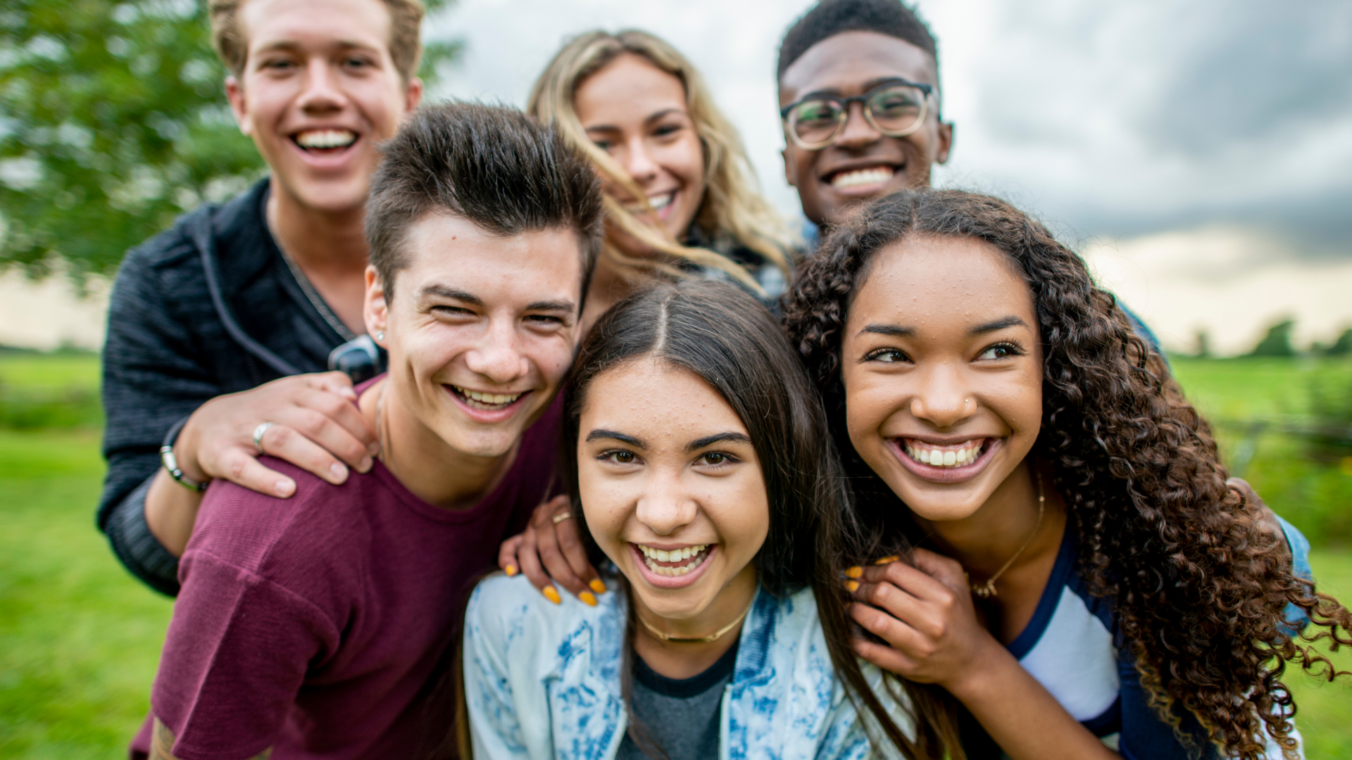 Smiling teenagers huddled in a group