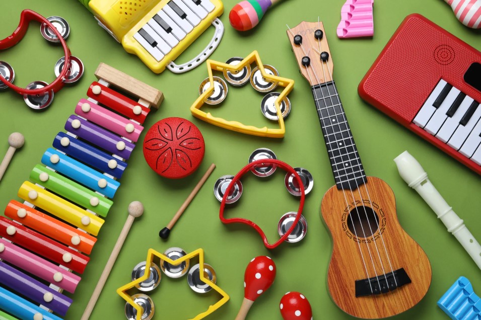 Colourful image of musical instruments including a ukulele, xylophone and children's keybaords