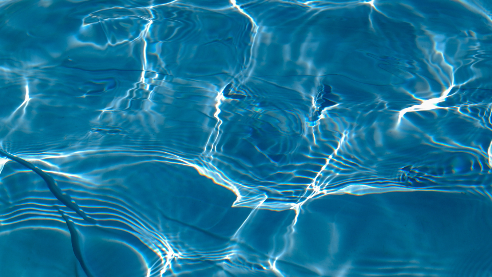 Light refracting on close-up of swimming pool water