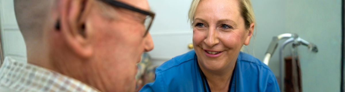 older man speaking to a health professional
