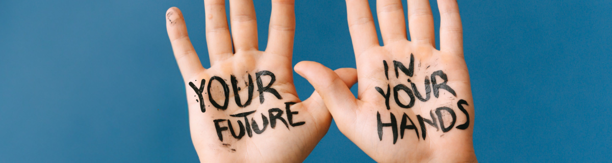 Two hands on a blue background with text written on palms: your future is in your hands