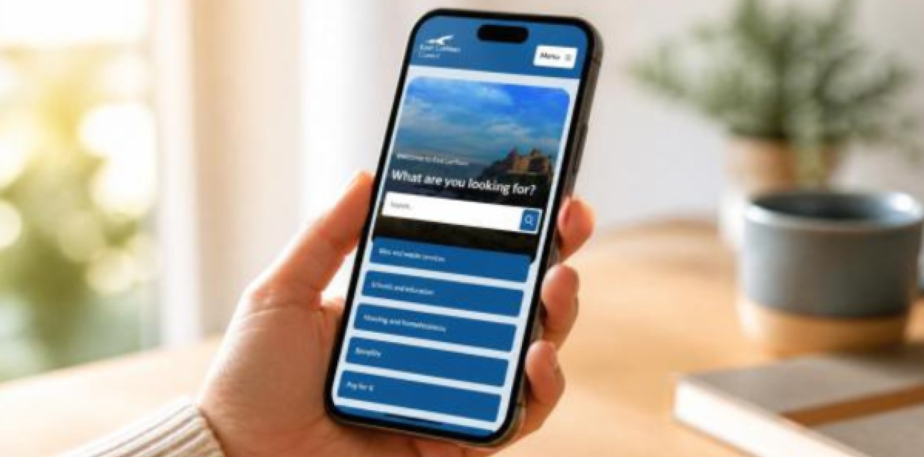 Someone holding a smartphone with the new council website on screen