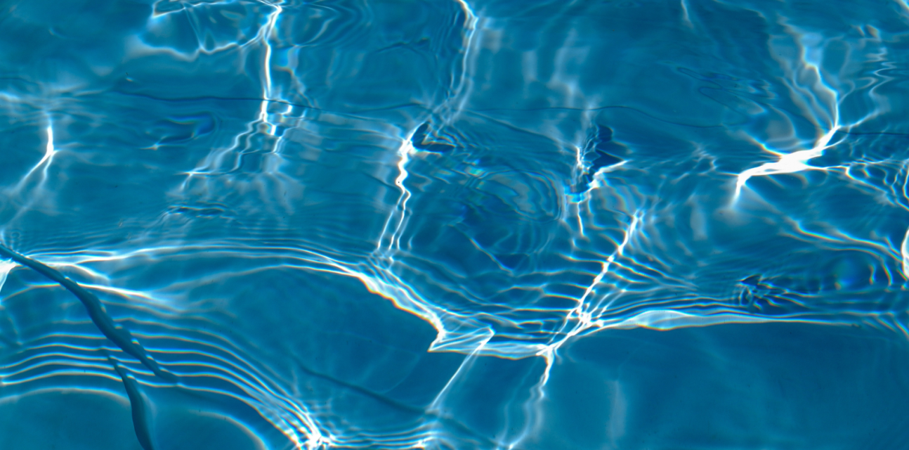Light refracting on close-up of swimming pool water